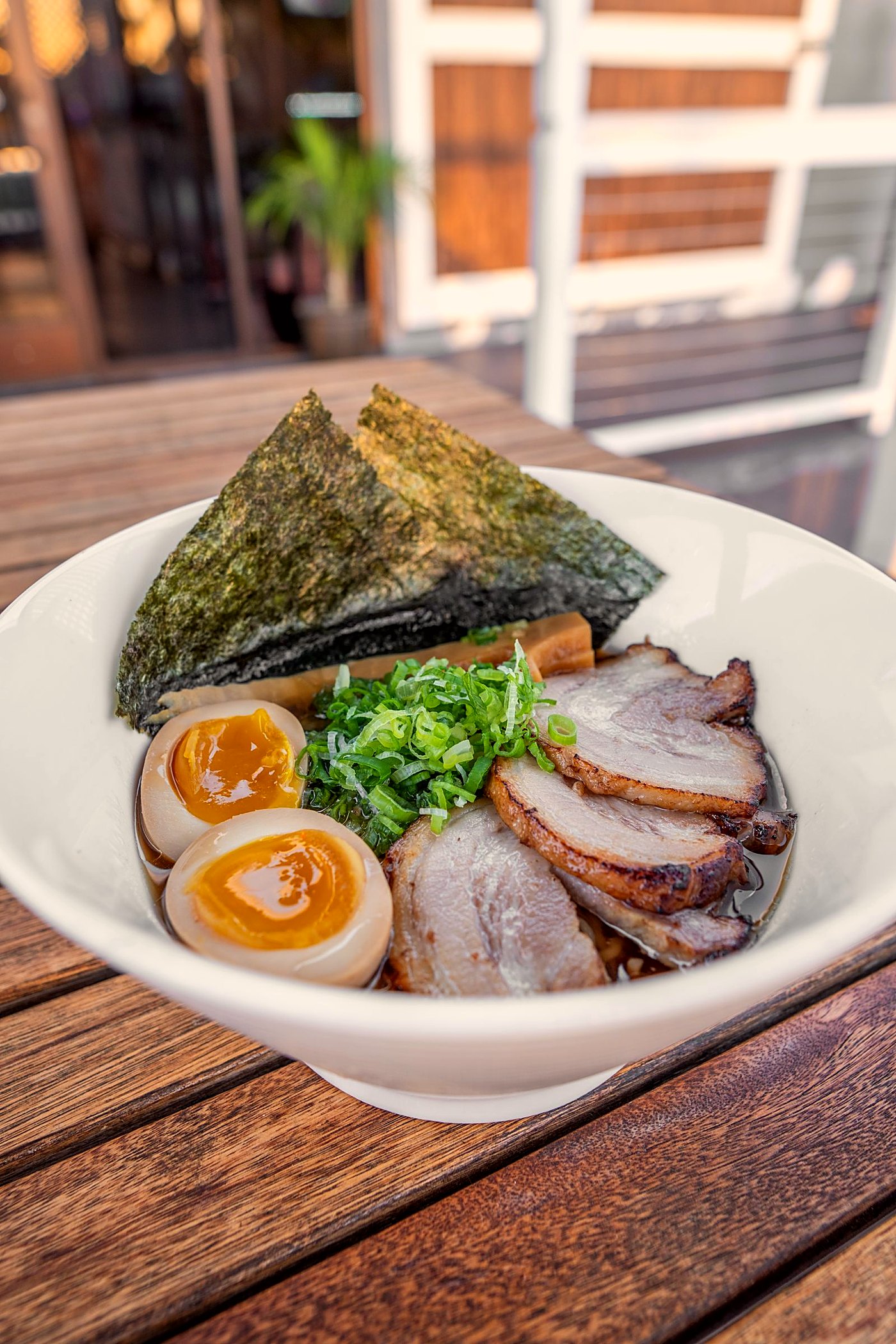 A bowl of tonkotsu ramen with chashu and a seasoned egg